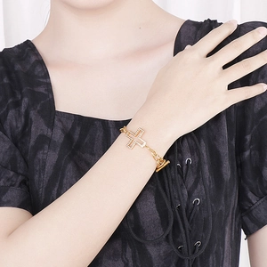 Retro gold cross bracelet with zircon stones and OT toggle clasp on a female wrist