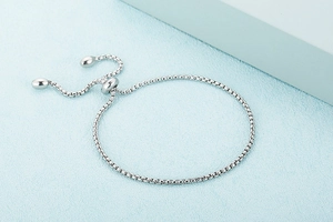 Detail of silver box chain bracelet with adjustable slide clasp and polished finish