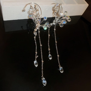 Macro detail of silver butterfly ear cuff with shimmering crystal beaded tassels