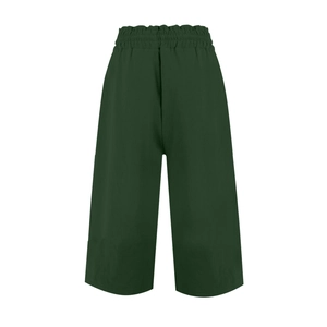 Detail view of high waist elastic waistband on dark green linen wide-leg shorts