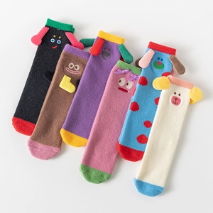 Flat lay detail of six pairs colorful cartoon coral fleece warm socks with 3D animal ears