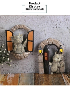 Detail of miniature dragon figurines with stone texture and warm LED lights for Halloween