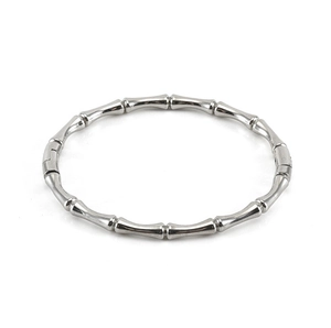 Detailed top view of a polished silver bamboo-shaped bangle on a white background