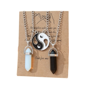 Macro detail of hexagonal crystal pendants and yin yang charms on display card