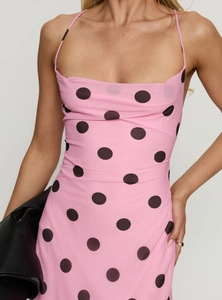 Detail of pink polka dot bodycon dress showing backless design with crisscross tie straps