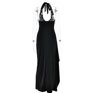 Detail of elegant black backless halter maxi dress with sleek draping on a white background