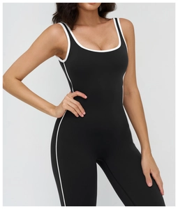 Close-up of contrast white piping on the square neckline of this black yoga bodysuit