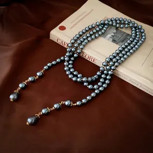 French retro multi-layer long pearl necklace with gold accents and teardrop pendants