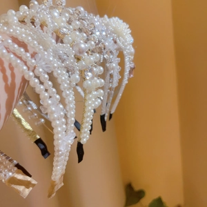 Detail of French vintage pearl and rhinestone headbands with elegant floral bow designs