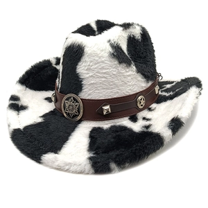 Detail of cow print cowboy hat featuring brown leather band with metal star studs