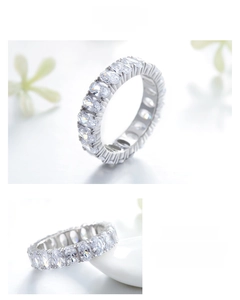 Macro detail of silver oval-cut diamond eternity ring with elegant claw setting