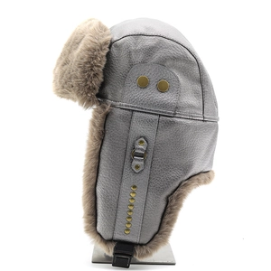 Detail of grey PU leather trapper hat with thick brown faux fur lining and metal rivets