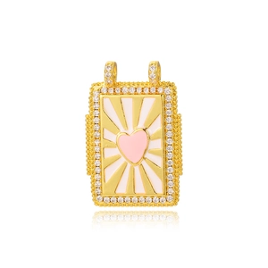 Close-up of golden rectangular tarot pendant with pink enamel heart and zircon edges