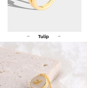 Detail of golden tulip relief on white shell stone ring with elegant texture