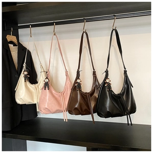 Four large capacity crossbody bags in various colors with cute monkey charms and drawstrings