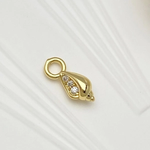 Detailed close-up of shell pendant with gold plating and white zircon inlay details