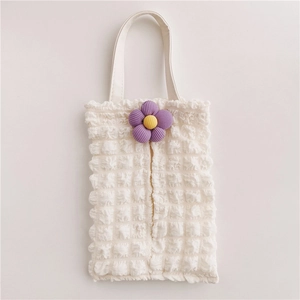 Detail of white bubble texture fabric car tissue box with a purple floral ornament