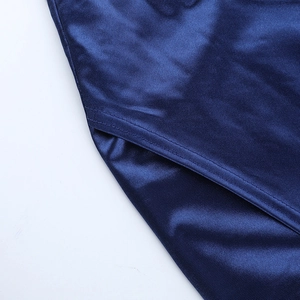 Detailed view of the dark blue satin fabric and precision stitching of the off-shoulder dress