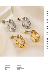 Detail of multi-layered U-shaped earrings in polished gold and silver stainless steel
