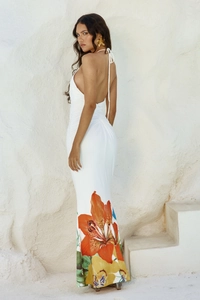 Detail of white halter neck dress with vibrant orange flower print and backless cut