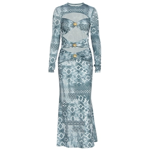 Detail of the waist cut-out design with gold flower buckles on the long printed dress