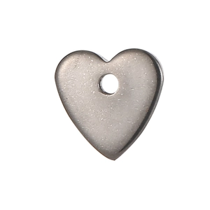 Close-up of heart-shaped stainless steel pendant with brushed metal finish and hole
