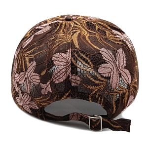 Detail of adjustable metal buckle and floral lace embroidery on a mesh baseball cap