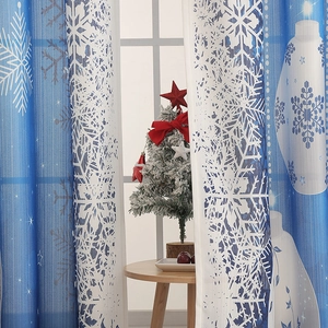 Detailed texture of blue and white Christmas curtains with snowflake and ball patterns