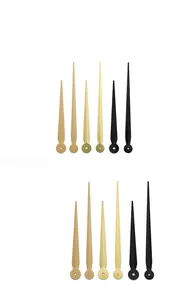 Macro view of gold and black DIY metal clock hands with mounting holes for repairs