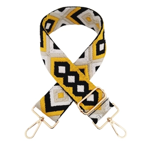 Detail of 5cm diamond jacquard bag strap with gold metal hooks and yellow-black weaving