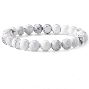 Macro detail of natural white turquoise beads with grey marble texture on round bracelet