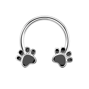 Close-up of silver horseshoe septum ring with black claw print charms on white background