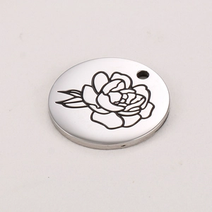 Detailed view of silver stainless steel round pendant with engraved birth month flower
