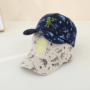 Kids baseball caps in navy and beige featuring dinosaur embroidery and bone prints