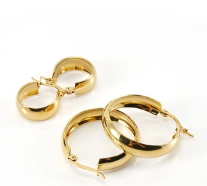 Detail of 18K gold stainless steel hoop earrings with secure snap closure mechanism