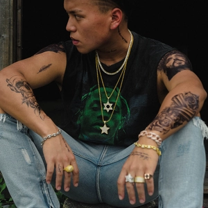 Hip hop style gold Star of David pendant necklace worn by model in street fashion setting
