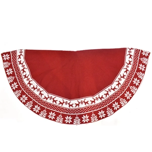 Close-up of red knitted Christmas tree skirt featuring white reindeer and snowflake patterns