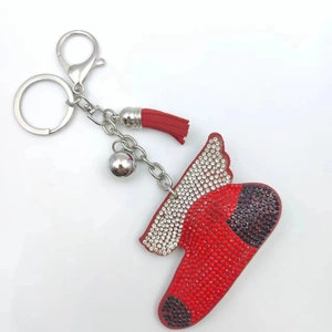 Detailed view of a red Christmas boot keychain with sparkling rhinestones and a red tassel