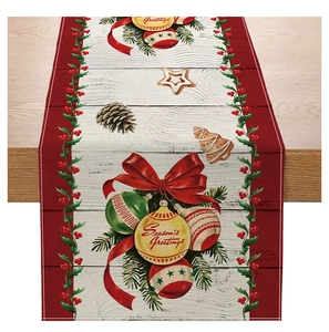 Detail of Christmas table runner with printed ornaments and Season's Greetings on wood