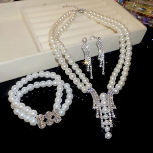 Detailed view of luxury pearl and crystal jewelry set with earrings and necklace