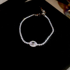 Macro shot of silver zircon oval tennis bracelet on elegant black velvet background