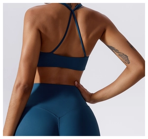 Detail view of the criss-cross back straps and high-waisted fit on a blue yoga set