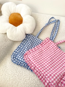 Detailed top view of plaid tote bags with ruffle edges in blue and pink fabric