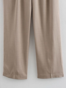 Detail of khaki straight-leg trousers showing high-quality fabric texture and stitching