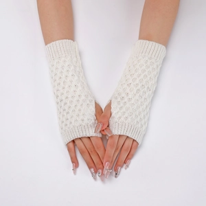 Detail of white knit fingerless gloves with intricate diamond hollow pattern textures