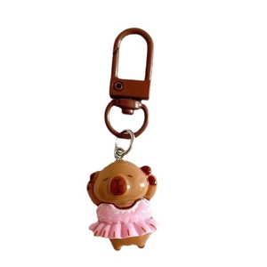 Cute brown capybara keychain wearing a pink floral ballet tutu on white background