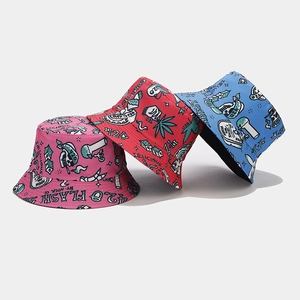 Detailed view of bucket hats featuring street art graffiti and cannabis leaf patterns
