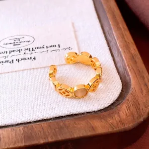 Adjustable golden hollow coin ring with elegant white cat-eye stones for women