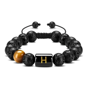 Macro detail of natural tiger eye stone and volcanic rock bead bracelet with letter H
