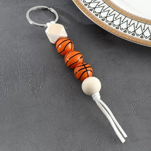 Detail of beaded sports keychain with basketball beads and wooden geometric accents